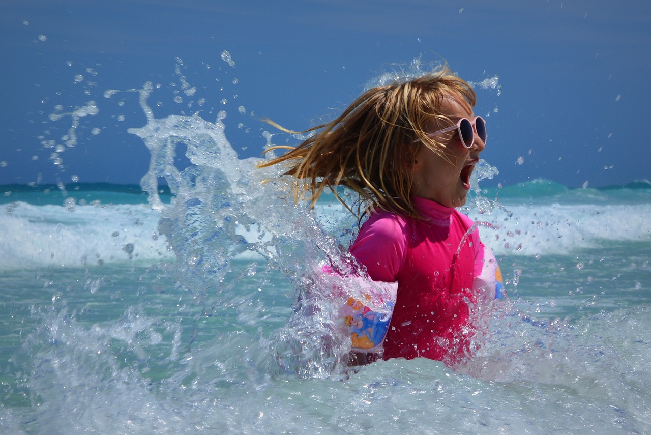 Girl splashing in ocean